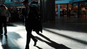 Traveler walking through a sunlit modern airport terminal