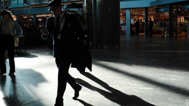 Traveler walking through a sunlit modern airport terminal