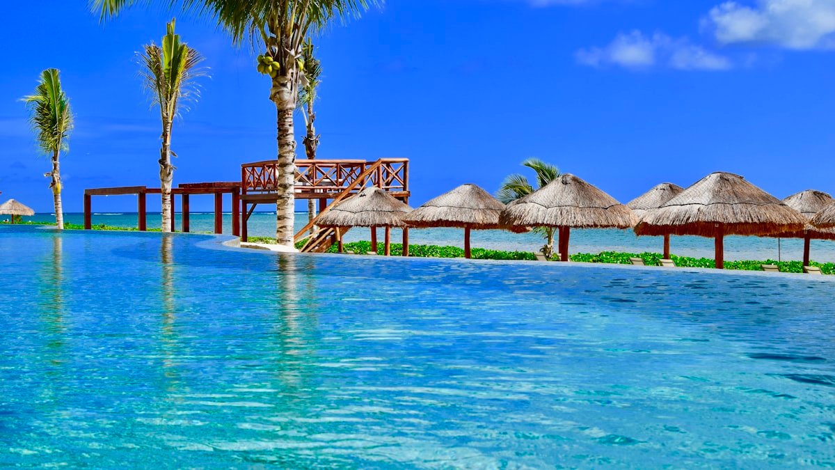 Wooden pier and palapa huts on the water in Puerto Morelos