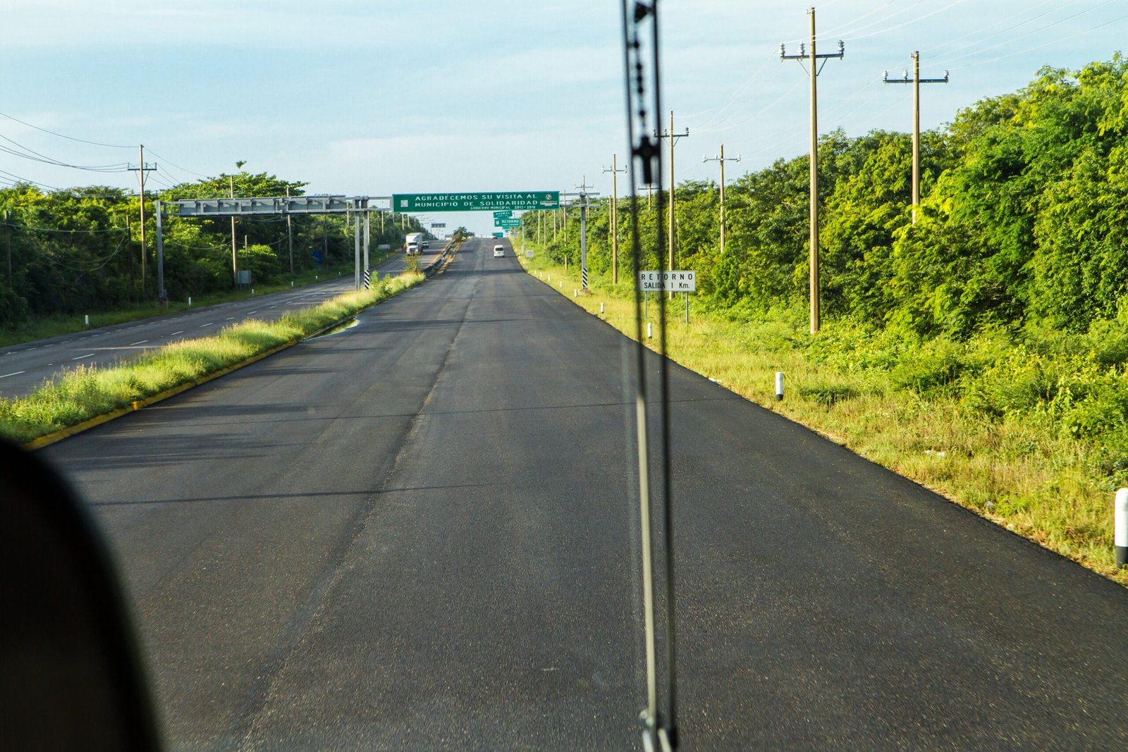 Federal Highway 307 passing through Tulum, Quintana Roo - tropical landscape with vegetation and road marking the journey south toward Tulum