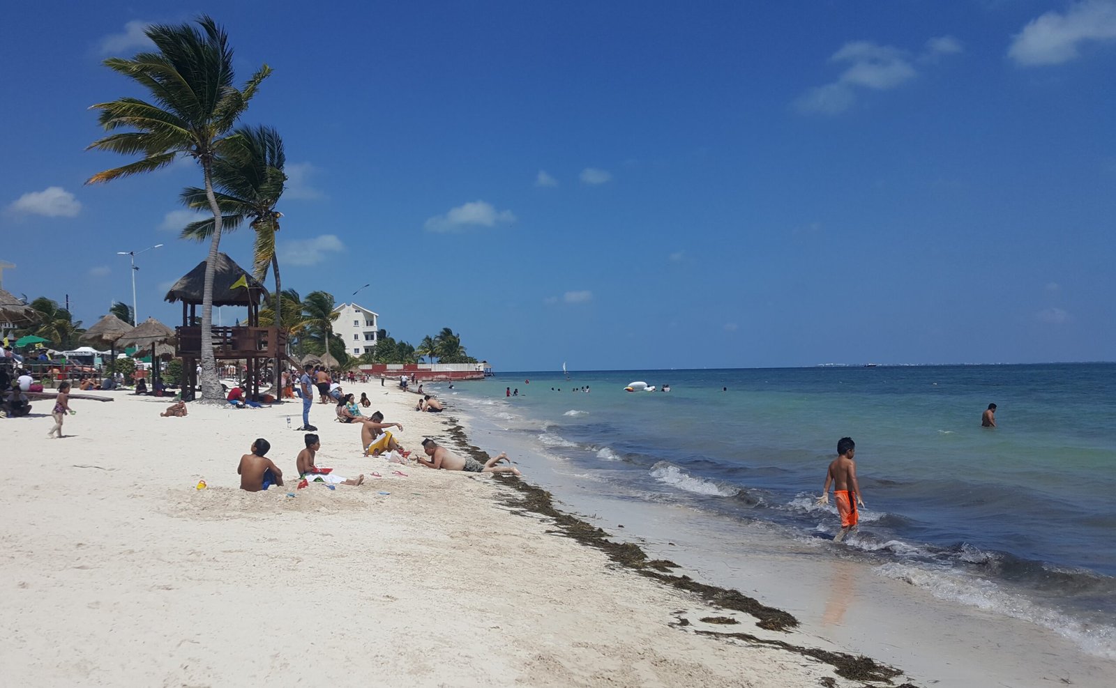 Families on a Cancún beach in early March, a calmer moment inside the high season before spring break crowds arrive