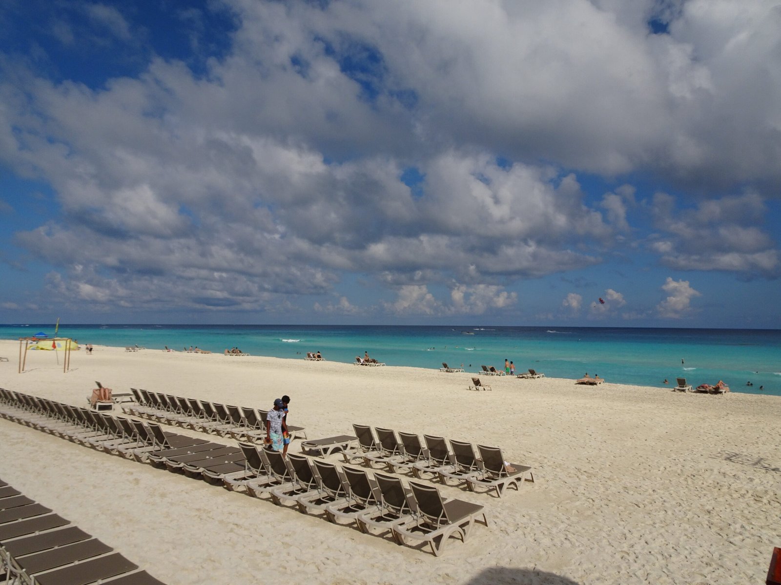Rows of beach loungers with a kiteboarder in the water off the Cancún Hotel Zone, Quintana Roo, Mexico