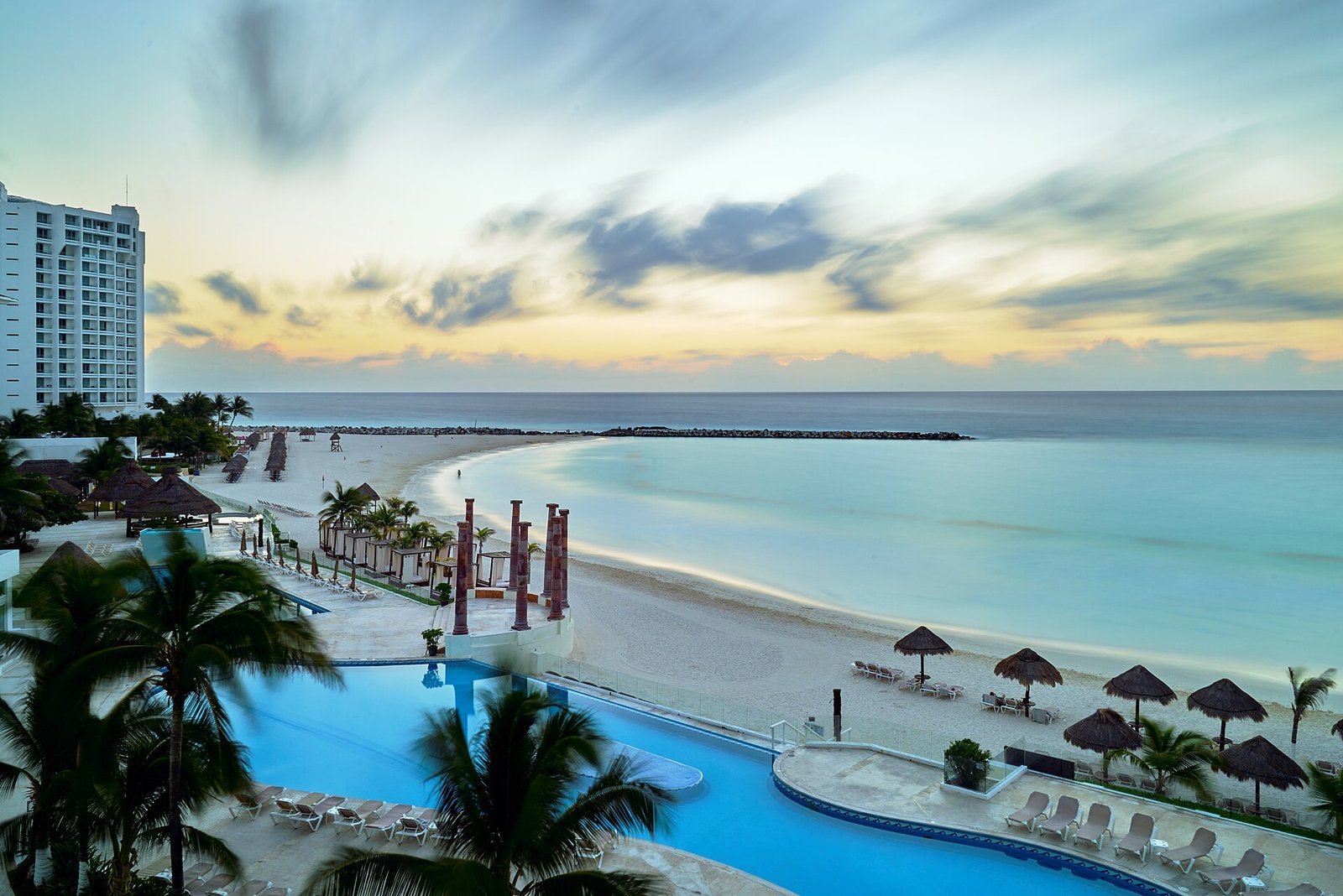 Wide view of the Cancun shoreline with hotels and beachgoers