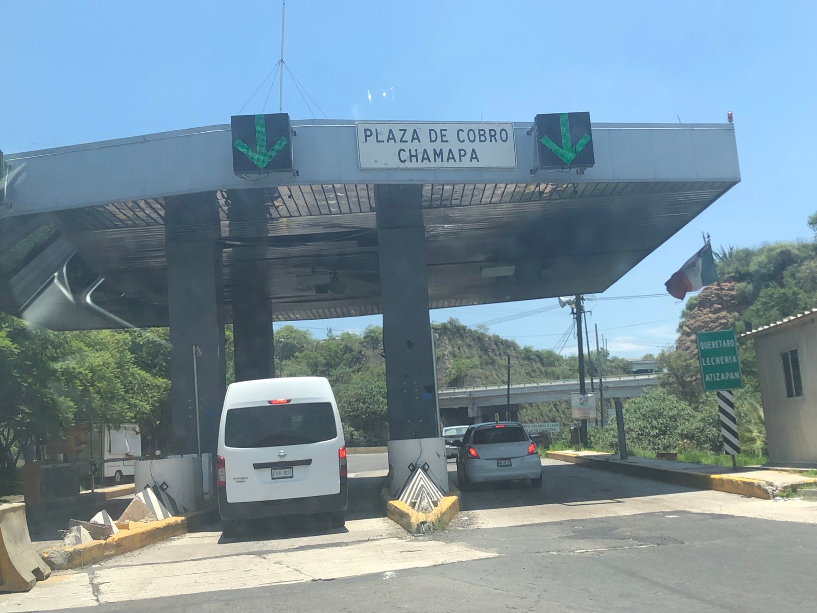 Toll booth (caseta de cobro) on a Mexican federal toll highway with cars passing through