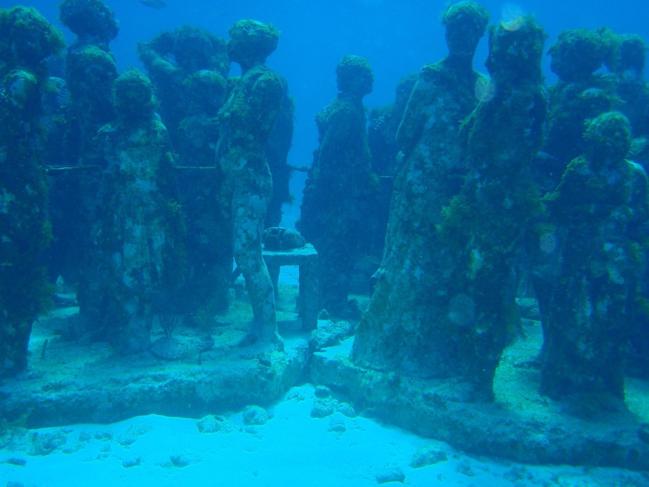 Submerged human figure sculptures of The Silent Evolution at the MUSA underwater museum near Cancun, Quintana Roo, Mexico