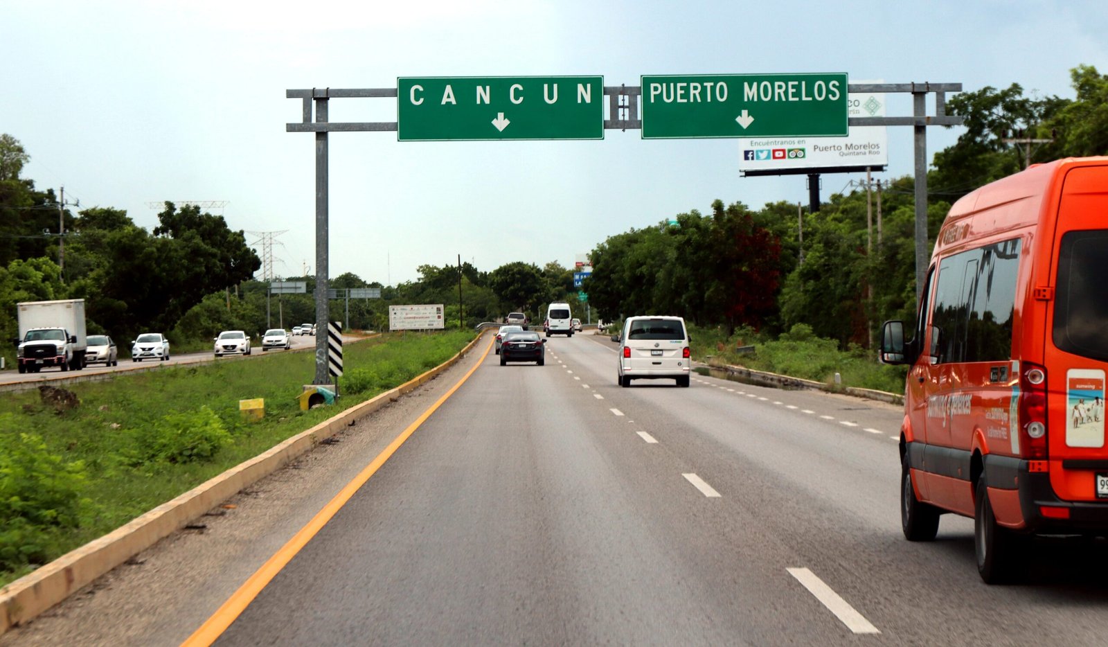 Highway sign on Federal Highway 307 pointing toward Cancun near Puerto Morelos, Quintana Roo