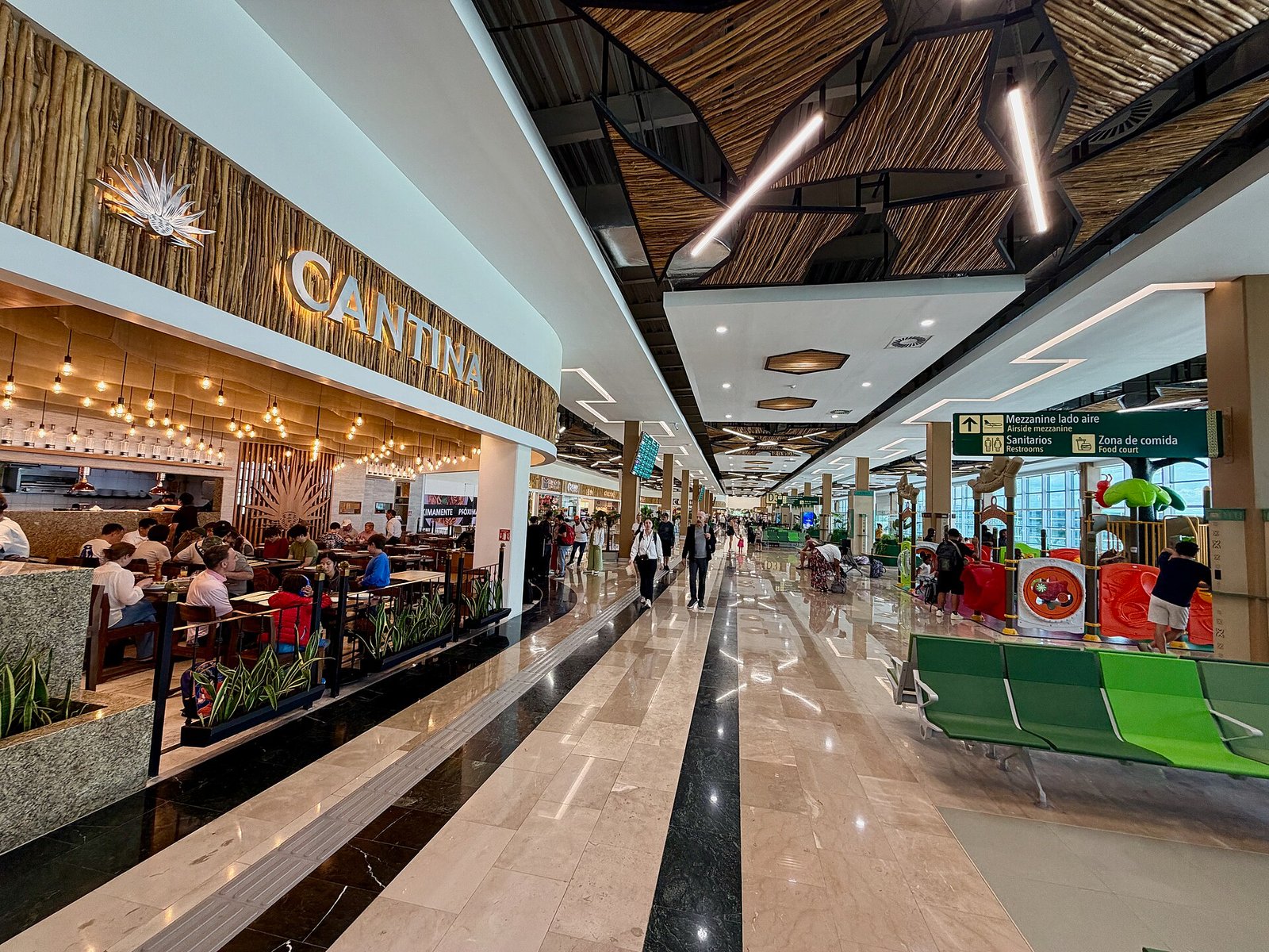 Interior concourse of Tulum International Airport with restaurants and seating areas