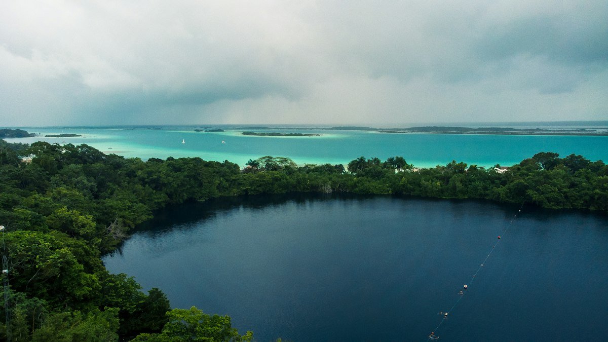 Aerial view of Cenote Azul surrounded by jungle in Bacalar, Quintana Roo