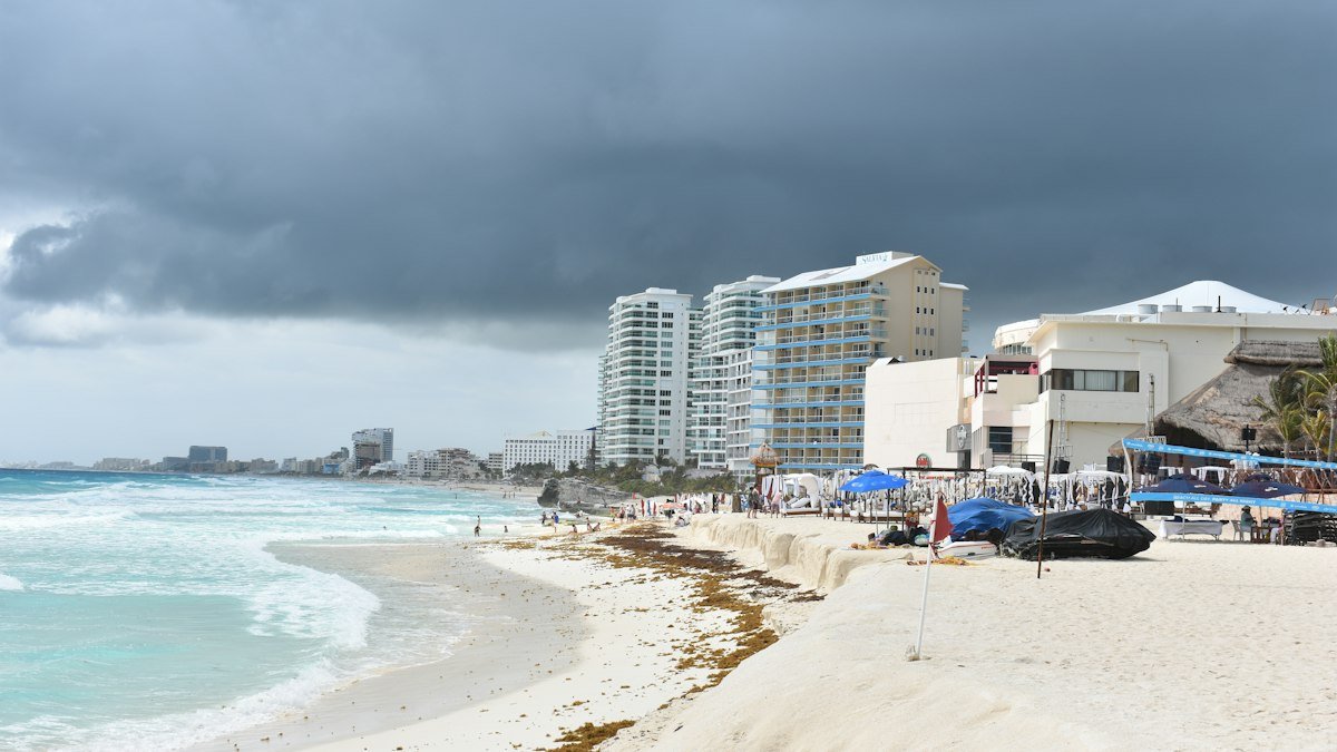 Sandy beach lined with hotel and condo towers in Cancún