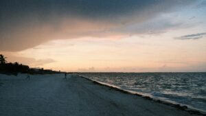 Beach in Cancún at sunset with dramatic clouds over the Caribbean