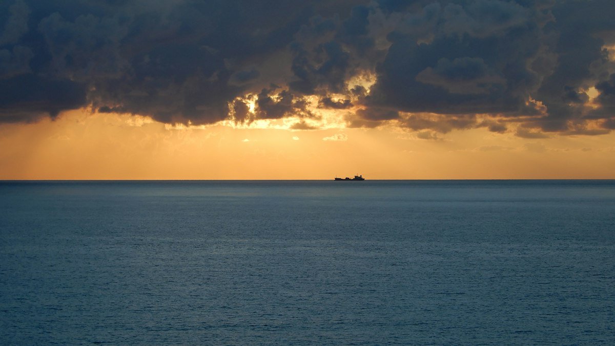 Cloudy sky over the Caribbean off Cancún with a ship on the horizon