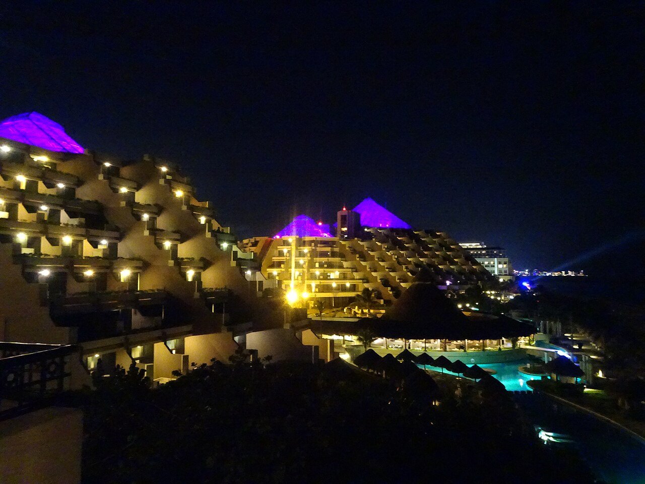 Resort buildings lit up at night in the Cancun Hotel Zone, photographed in November 2018