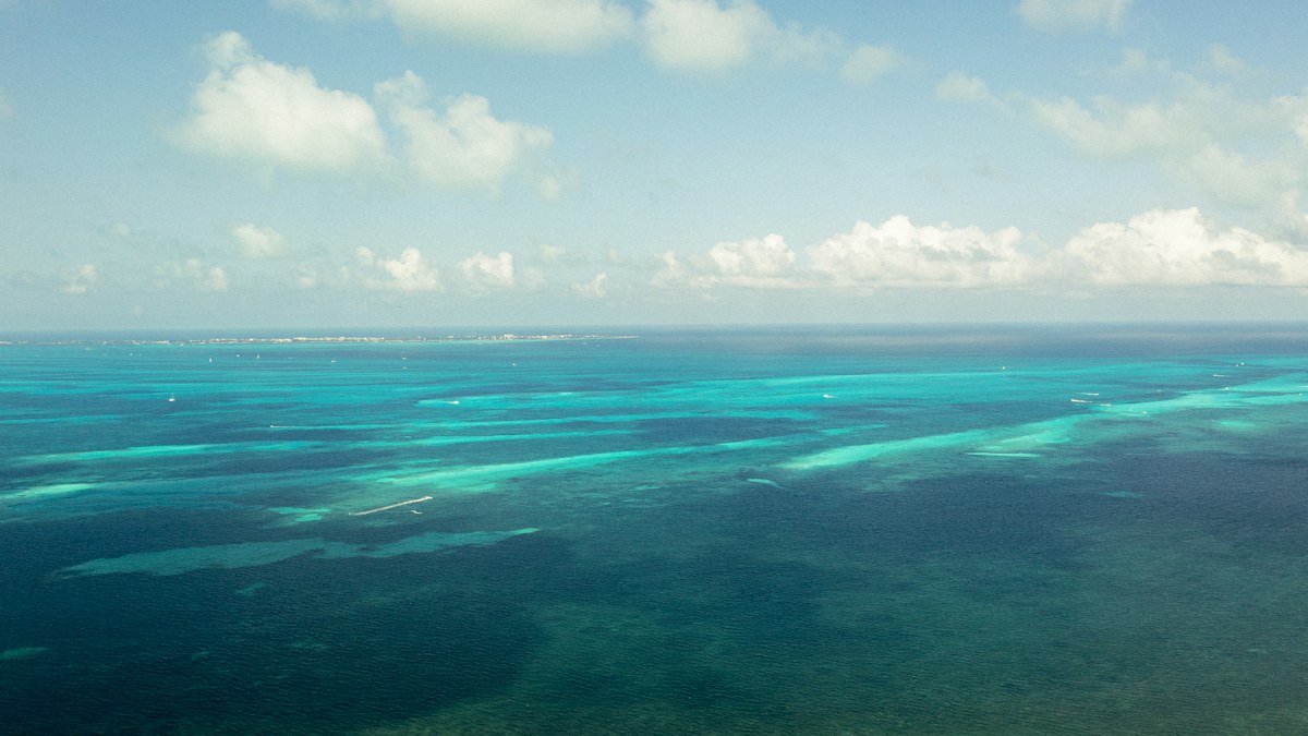Lagoon, mangroves and the Caribbean seen from a plane window over Cancún
