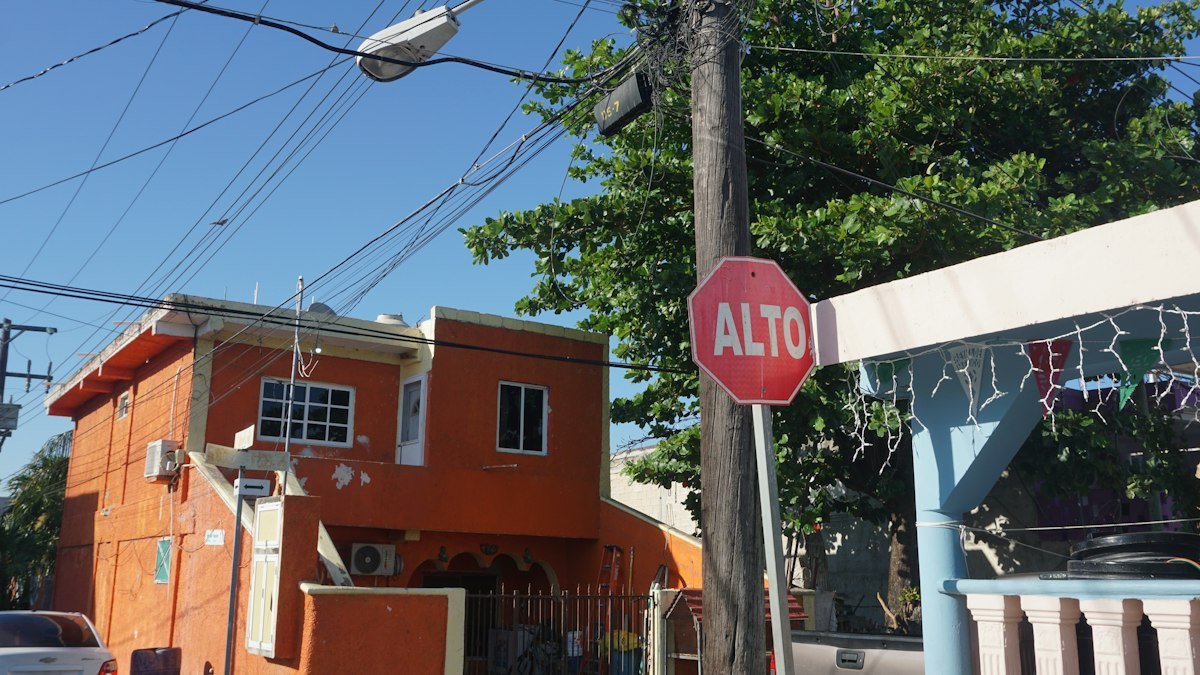 Red stop sign at the side of a road in Cancún, Quintana Roo