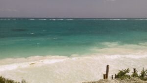 Turquoise Caribbean Sea seen from a rocky cliff near Cancún on a clear day