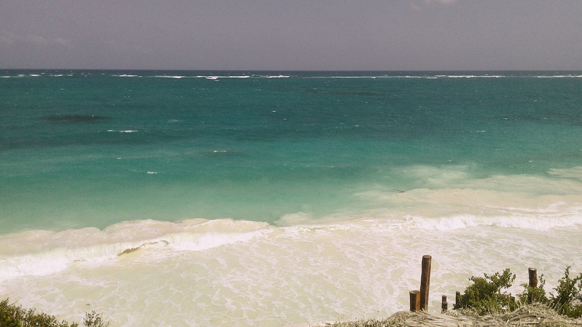 Turquoise Caribbean Sea seen from a rocky cliff near Cancún on a clear day