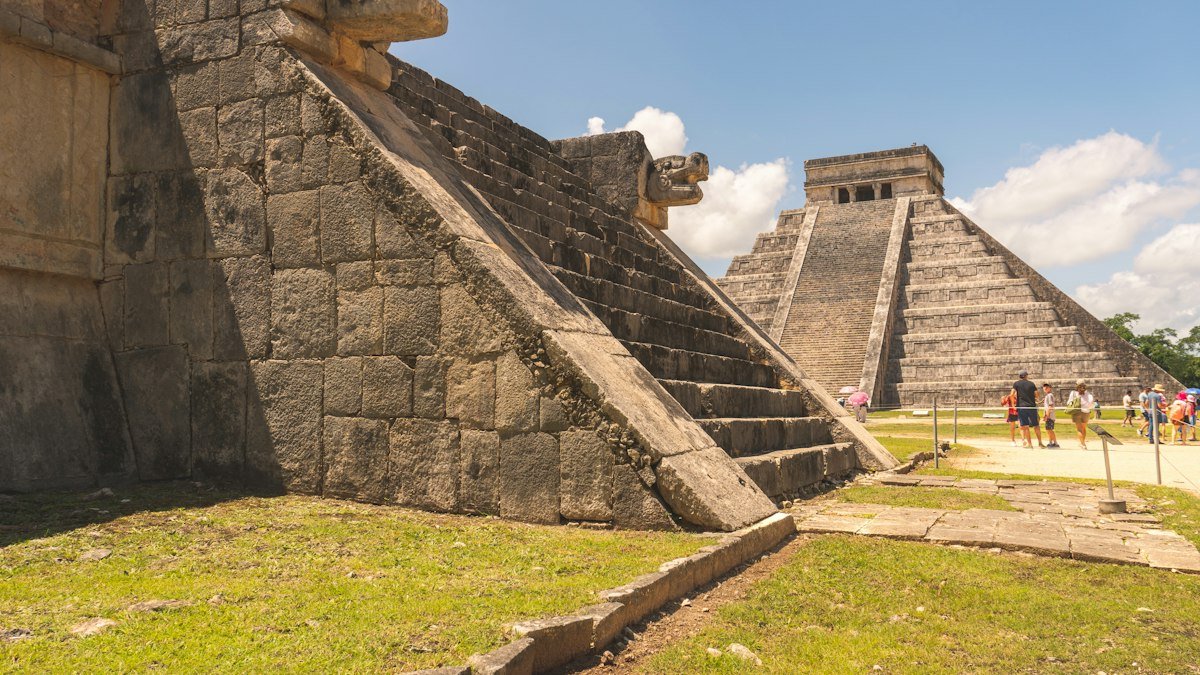 Stone serpent heads at the base of the stairs of El Castillo, the Temple of Kukulcán, Chichén Itzá