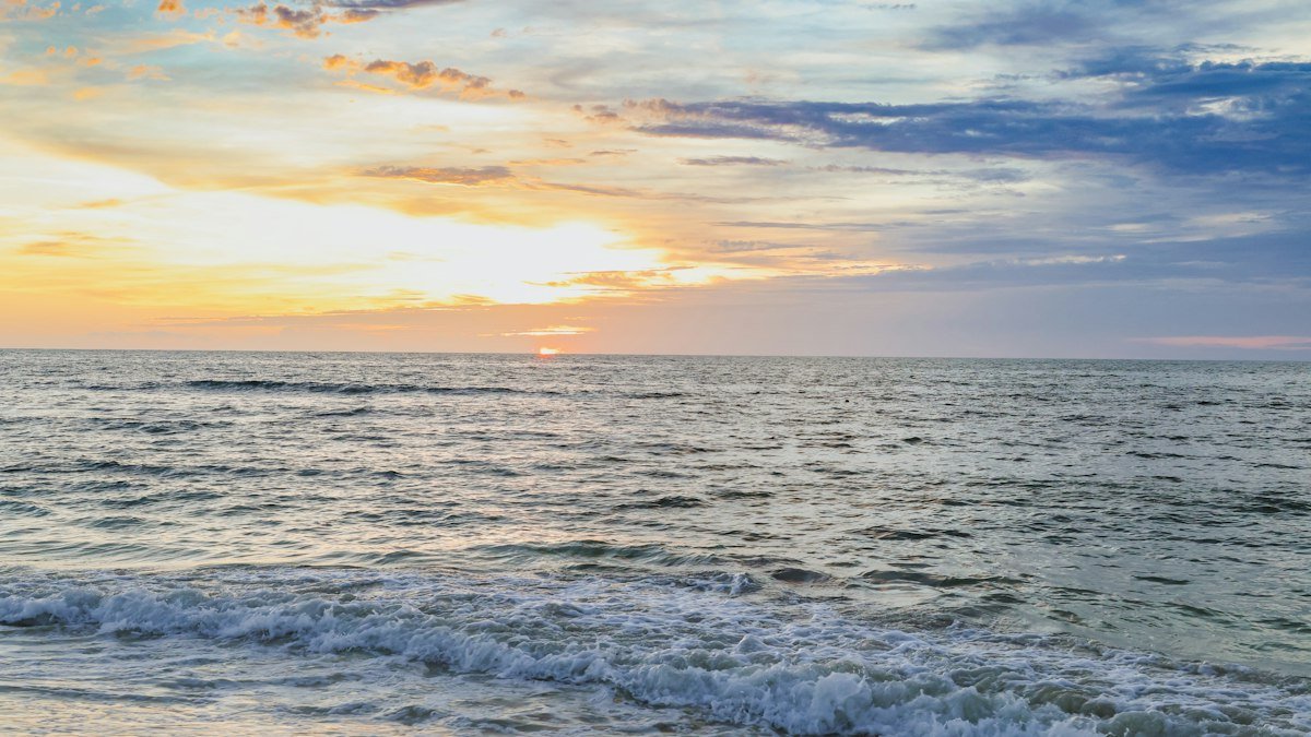 Sunset with colorful clouds over a calm sea in Costa Mujeres, north of Cancún