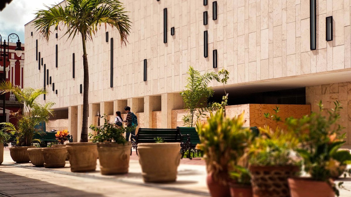 Corner of the Palacio de la Música building with potted plants in central Mérida, Yucatán