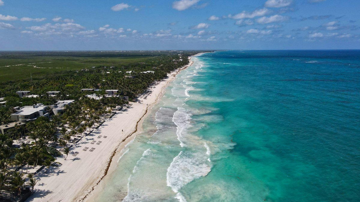Aerial view of the long beach strip and jungle along the Tulum coast, Quintana Roo