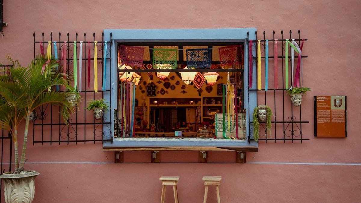 Pink house front with a blue window on a street in Valladolid, Yucatán, at golden hour
